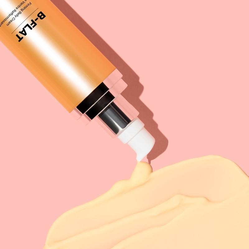 B-FLAT firming belly cream with smooth yellow texture shown on pink background